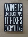 A sign with the saying Ã¢â¬ÅWine is like duct take it fixes everythingÃ¢â¬Â.